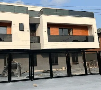 Residential building under construction on Rosanwo Street, Aguda, Lagos, with timber-clad and glazed facade